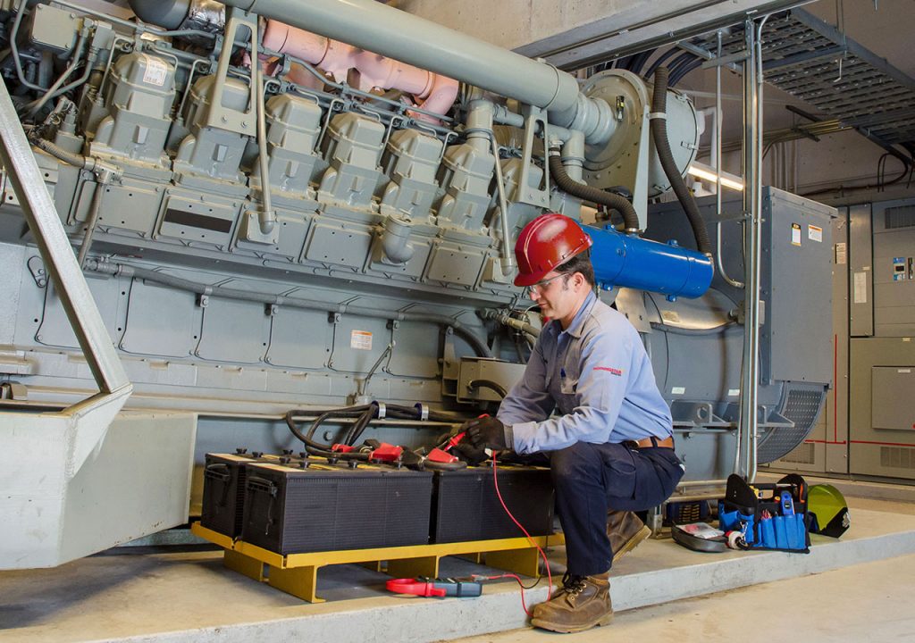 Morningstar technician fixing battery at a industrial site